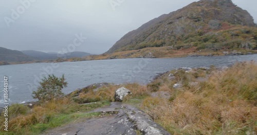 Exploring the Kerry region in Ireland with views of lakes and hills during a cloudy day