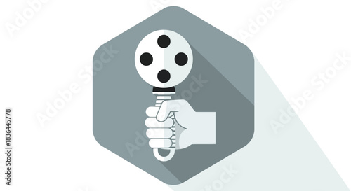 Hand holding a maraca with a gray hexagon background