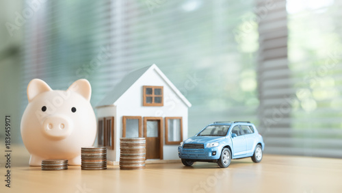 Piggy bank, stacked coins, model house, and toy car arranged together to represent late payment alerts, financial penalties, and overall money management for housing, loans, and personal budgeting.