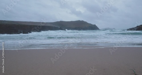 Exploring the Kerry Region in Ireland with waves crashing on the shore during a windy afternoon