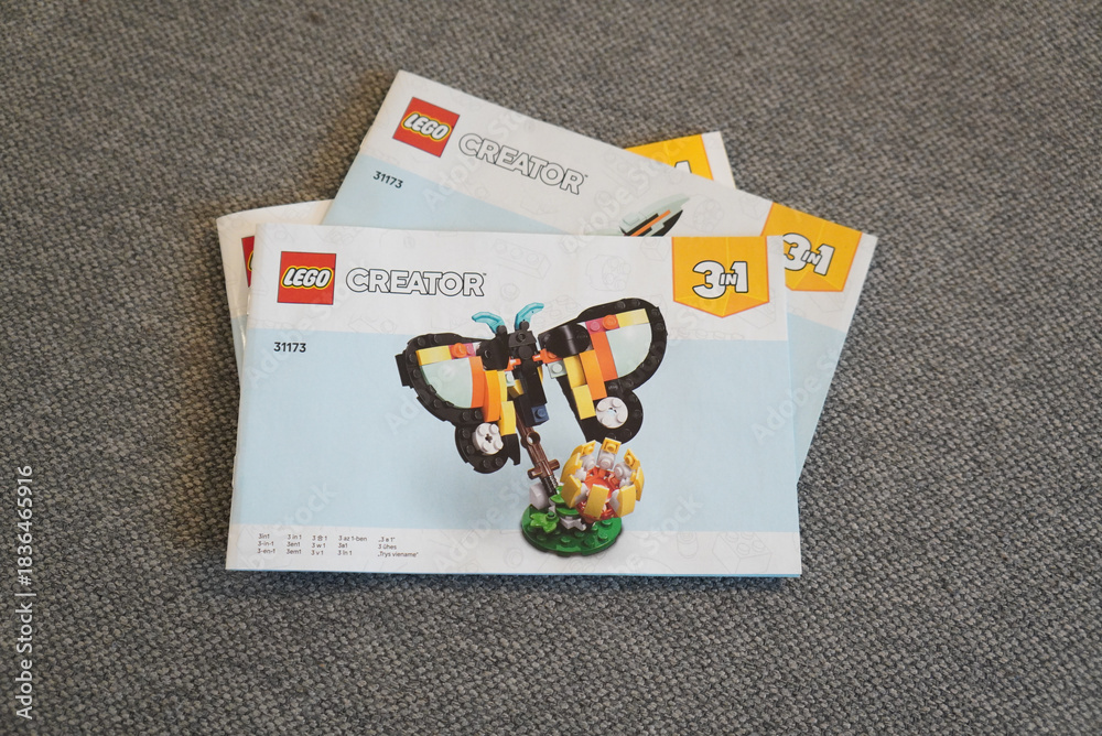 Obraz premium Lego Creator 3-in-1 Butterfly Instruction Manuals on a Gray Surface
