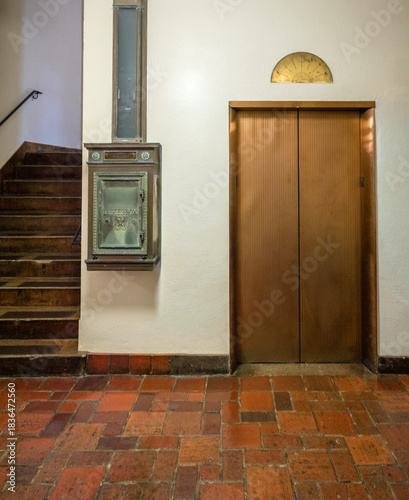 Copper Elevator Doors with a Bronze Floor Indicator and a 1920's Mail Slot and Box.