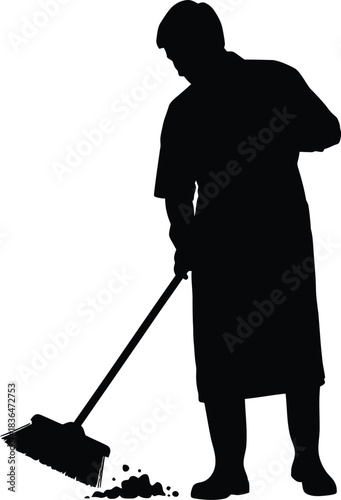 Silhouette of a person sweeping dirt or debris floor