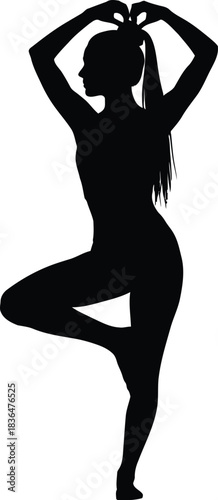 Silhouette of a woman practicing yoga tree pose with hands forming a heart shape above her head