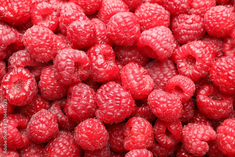 Naklejka premium Fresh ripe raspberries as background, top view
