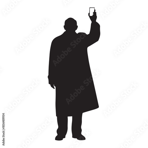 Silhouette of a man in a trench coat holding up a smartphone male person