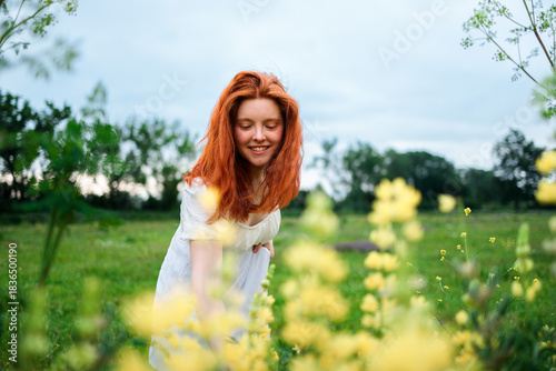 Young woman in a flowering field during a calm summer day