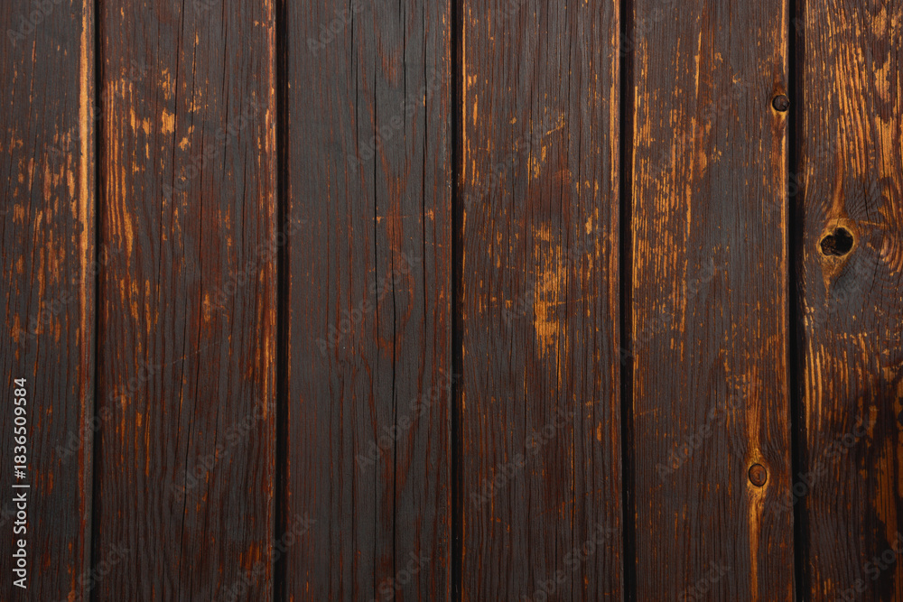 Naklejka premium Dark wood surface with a natural pattern. Background with a wood grain texture.