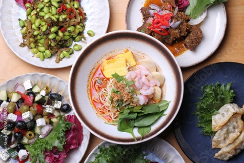 a variety of Asian food in plates on the table