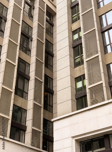 a close up photo of windows and facade pattern of a business apartment in luohu shenzhen china