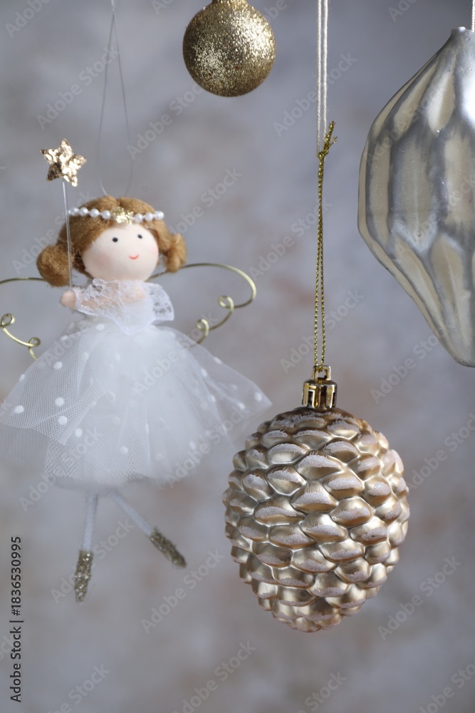 Naklejka premium Beautiful Christmas decor hanging near light grey wall, closeup