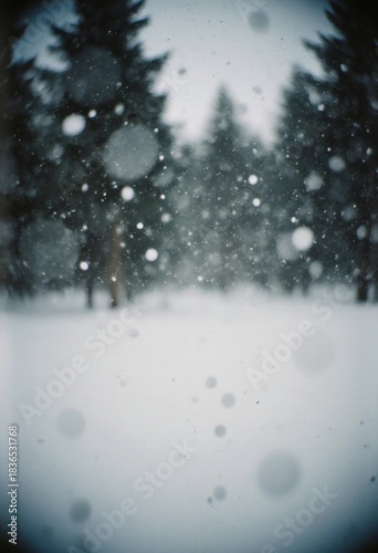 Snow falls softly in a forest area with tall trees. The ground is covered in white snow. The setting shows a mood of winter weather and cold temperature Generative AI
