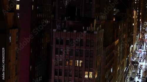New York City buildings and busy streets illuminated at night in a vibrant urban setting