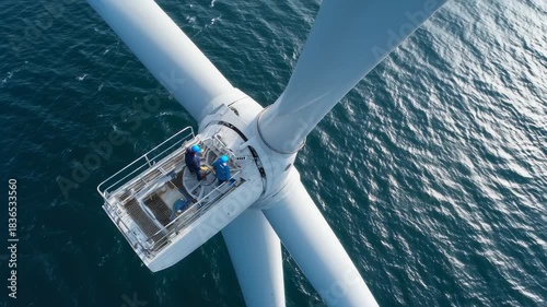 Engineers conduct maintenance on top of a wind turbine in the ocean during daylight, ensuring optimal performance of renewable energy systems