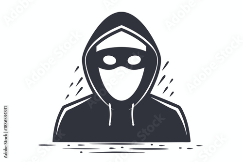 Masked hacker in a dark hood actively works on a laptop device