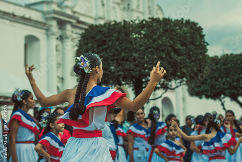 dance, dancer, traditional, celebration, festival, culture, performance, heritage, attire, colorful, music, event, community, joyful, outdoor, braided hair, flowers, crowd, expression, rhythm, movemen
