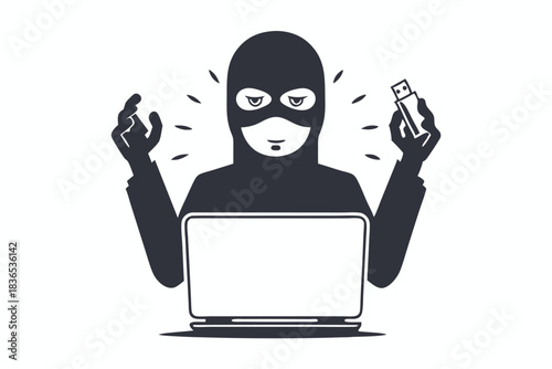 Masked hacker in hood uses laptop to perform cybercrime operations online now