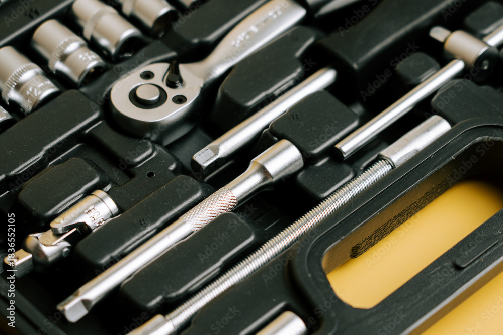 Fototapeta premium Set of various tools arranged neatly in a black storage case