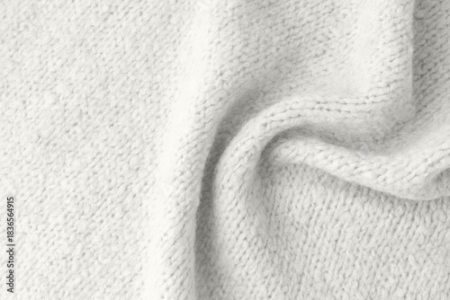 Light grey alpaca an cashmere wool mix texture as background with copy space. Trendy color 20246 year Cloud Dancer backdrop.