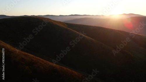 Sunrise light over rolling mountain ridges