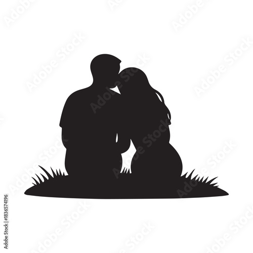 Silhouette of a loving couple embracing outdoors on a grassy hill