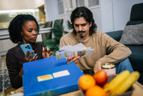 Young couple reviewing bills together