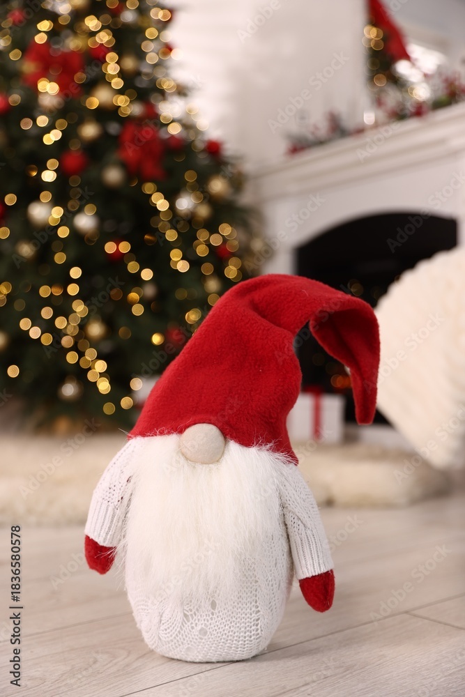 Obraz premium Funny Christmas gnome on floor in decorated room