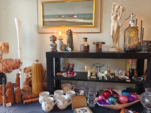 Vintage and everyday household items displayed in a thrift store, second-hand shop interior with retro objects and used goods for resale