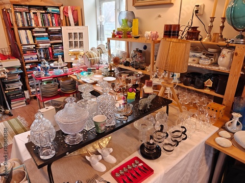 Vintage and everyday household items displayed in a thrift store, second-hand shop interior with retro objects and used goods for resale