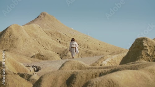 A Traveler�s feet step forward on a dry, rocky path. Christian and spiritual concept