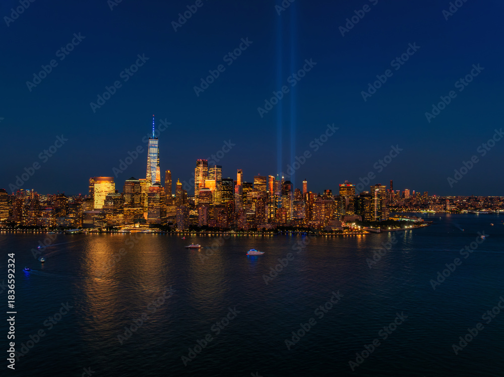 Obraz premium Aerial view of Manhattan at sunset with 911 memorial lights