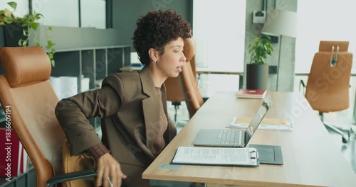 Businesswoman deep in thought while managing files and documents