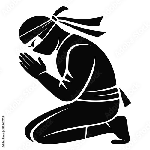 Silhouette of a ninja kneeling in prayer or meditation