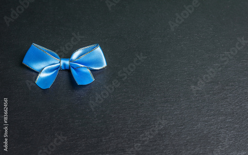 blu bow on black background