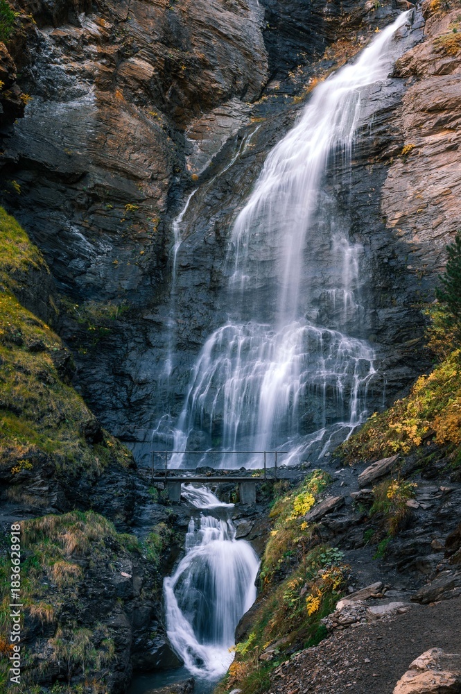 Obraz premium Tall Mountain Waterfall in Forest, Pyrenees