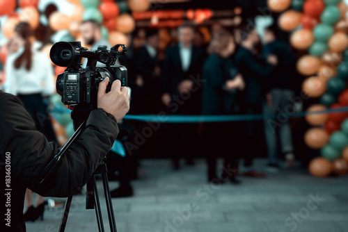 The cameraman is skillfully operating and filming with a professional digital camera, carefully adjusting the focus and composition to capture high‑quality footage