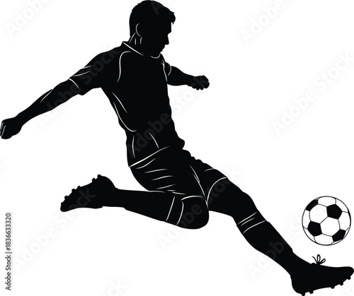 Silhouette of a soccer player kicking a ball in midair