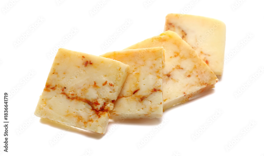 Obraz premium Slice cheese with red crushed paprika isolated on white background