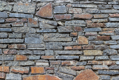 Laying a wall of granite tiles.