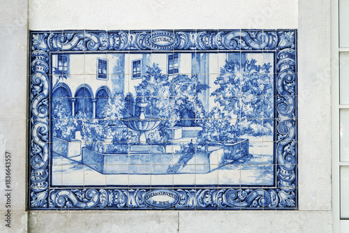 azulejos panel in Pinhal Novo station Portugal  featuring blue and white decorative patterns. The design includes stylized floral and geometric motifs arranged in horizontal bands.surrounding building