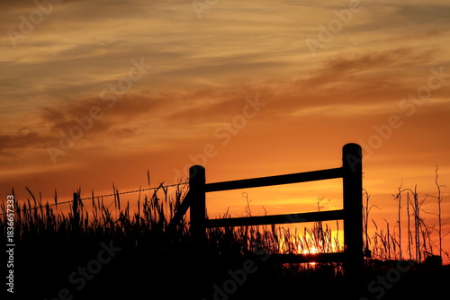 Sunset clouds fence silhouette farm 
