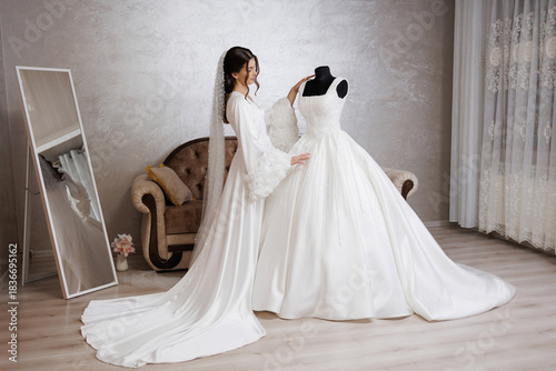 Bride fitting her wedding dress in a stylish dressing room with elegant decor