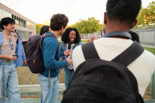 Diverse students conducting an interview and having fun on a university campus