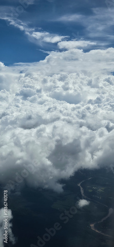 Aerial view above white clouds over landscape