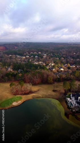 Vertical 4K aerial video of an upscale sub division in suburbs of USA shot early in the morning