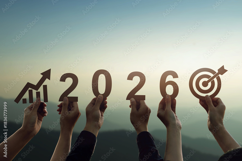 Obraz premium Hands holding 2026 numbers with growth chart and target icon at sunrise, symbolizing economic planning, business goals, financial strategy, long term vision, future success and growth.