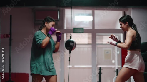 Female boxers sparring together during a gym training session