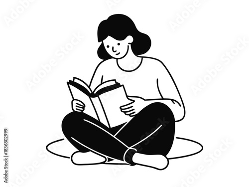 Person sitting cross legged reading a book