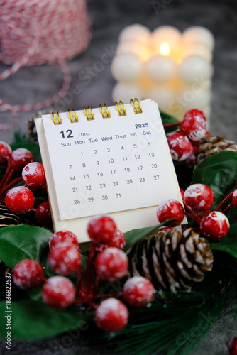 Season's greetings scene. Top view of Christmas decorations, balls, rustic star, holly berries, frosty spruce branches, confetti on green backdrop, perfect for messages or promo. text space concept