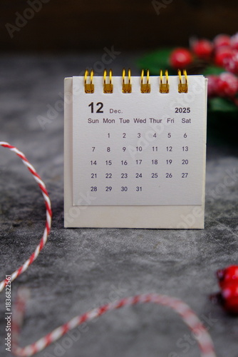 Season's greetings scene. Top view of Christmas decorations, balls, rustic star, holly berries, frosty spruce branches, confetti on green backdrop, perfect for messages or promo. text space concept